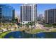 Beautiful high-rise condo building with lush landscaping and pond at 1233 N Gulfstream Ave # 401, Sarasota, FL 34236