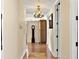 An interior hallway featuring beautiful hardwood flooring, neutral paint, and classic lighting at 1233 N Gulfstream Ave # 401, Sarasota, FL 34236