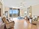 Spacious living room with floor-to-ceiling windows showcasing the waterfront, and cozy furniture at 1233 N Gulfstream Ave # 401, Sarasota, FL 34236