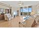 Spacious living room with floor-to-ceiling windows showcasing the waterfront, and cozy furniture at 1233 N Gulfstream Ave # 401, Sarasota, FL 34236