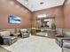 Welcoming lobby area with comfortable seating, modern lighting, and a TV displaying scenic views at 1233 N Gulfstream Ave # 401, Sarasota, FL 34236