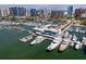 Aerial view of a marina filled with boats and yachts with city skyline in background and waterfront restaurants at 1233 N Gulfstream Ave # 401, Sarasota, FL 34236