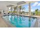 Beautiful indoor pool with chairs and stunning views of the surrounding palm trees and landscape at 1233 N Gulfstream Ave # 401, Sarasota, FL 34236