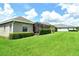 A lush green backyard with a view of the home featuring a screened patio at 12331 Halfmoon Lake Ter, Bradenton, FL 34211