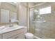 Bathroom featuring a glass-enclosed shower and a modern vanity with decorative accents at 12331 Halfmoon Lake Ter, Bradenton, FL 34211