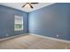 Bedroom showcasing blue walls, neutral carpet and a window providing natural light at 12331 Halfmoon Lake Ter, Bradenton, FL 34211