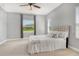 Light and airy bedroom with a ceiling fan and large window offering a beautiful outdoor view at 12331 Halfmoon Lake Ter, Bradenton, FL 34211