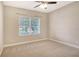 Bedroom with neutral walls, neutral carpet and a window providing natural light at 12331 Halfmoon Lake Ter, Bradenton, FL 34211