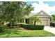 Charming single-story home featuring a manicured lawn, lush landscaping, and an attached two-car garage at 12331 Halfmoon Lake Ter, Bradenton, FL 34211