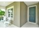 Charming front porch with cozy seating, a perfect spot to welcome guests to this inviting home at 12331 Halfmoon Lake Ter, Bradenton, FL 34211