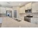 Bright kitchen with stainless steel appliances, white cabinets and granite countertops at 12331 Halfmoon Lake Ter, Bradenton, FL 34211