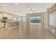 Open concept living area with tile flooring, modern lighting, and seamless transition to the outdoor living space at 12331 Halfmoon Lake Ter, Bradenton, FL 34211