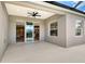 Covered patio with sliding glass doors providing easy access to indoor and outdoor living spaces at 12331 Halfmoon Lake Ter, Bradenton, FL 34211