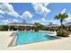 Resort-style pool area with covered seating and clear blue water, perfect for relaxation and recreation at 12331 Halfmoon Lake Ter, Bradenton, FL 34211
