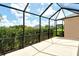 Screened patio with views of lush landscaping and a glimpse of the surrounding neighborhood at 12331 Halfmoon Lake Ter, Bradenton, FL 34211