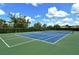 Well-maintained tennis court with vibrant blue and green surfaces, ready for sports and recreation at 12331 Halfmoon Lake Ter, Bradenton, FL 34211