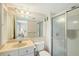 Bathroom featuring a vanity, toilet, and a shower with sliding glass doors at 1350 N Portofino Dr # 402, Sarasota, FL 34242