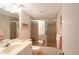 Bathroom features a vanity with a mirror, toilet, and shower-tub combo with sliding doors at 1350 N Portofino Dr # 402, Sarasota, FL 34242