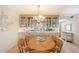 Dining room with a wooden table, wicker chairs, and built-in display cabinets with glass doors at 1350 N Portofino Dr # 402, Sarasota, FL 34242