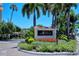 Siesta Harbor entrance sign with lush landscaping and palm trees under a clear blue sky at 1350 N Portofino Dr # 402, Sarasota, FL 34242