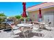 Community grilling area features multiple grills and tables with chairs, perfect for outdoor cooking and entertaining at 1350 N Portofino Dr # 402, Sarasota, FL 34242