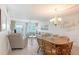 Bright living and dining area featuring waterfront views and a cozy seating arrangement with chandelier at 1350 N Portofino Dr # 402, Sarasota, FL 34242