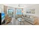 Comfortable living room offering natural light, stylish furnishings, and beautiful waterfront scenery at 1350 N Portofino Dr # 402, Sarasota, FL 34242