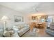 Inviting living area featuring water views, comfortable seating, and a built-in dining area at 1350 N Portofino Dr # 402, Sarasota, FL 34242