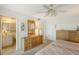 Main bedroom featuring ensuite bathroom, large dresser, and ceiling fan at 1350 N Portofino Dr # 402, Sarasota, FL 34242
