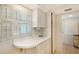 Pantry area features white cabinetry with countertop space, drawers, and tiled flooring at 1350 N Portofino Dr # 402, Sarasota, FL 34242