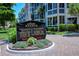 Siesta Harbor directory sign with lush tropical foliage and brick paver base at 1350 N Portofino Dr # 402, Sarasota, FL 34242