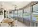 Charming sun room with waterfront views, comfortable seating, and a ceiling fan for year-round comfort at 1350 N Portofino Dr # 402, Sarasota, FL 34242