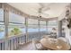 Bright and airy sun room boasting panoramic water views and comfortable seating area with tiled floor at 1350 N Portofino Dr # 402, Sarasota, FL 34242
