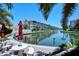 Scenic waterfront view with patio table, seating, and manicured grounds at 1350 N Portofino Dr # 402, Sarasota, FL 34242