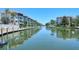Scenic waterfront view of the canal, condos, and boat docks on a sunny day at 1350 N Portofino Dr # 402, Sarasota, FL 34242
