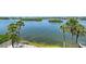 Scenic waterfront view with palm trees, serene waters, and a picturesque landscape, providing a tranquil setting at 1350 N Portofino Dr # 402, Sarasota, FL 34242