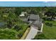 Desirable home features screened pool, verdant landscaping, and a long driveway to a 2-car garage at 13514 4Th E Plz, Bradenton, FL 34212