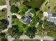 Stunning aerial view showcases a home with a pool, pond, and surrounding trees at 13514 4Th E Plz, Bradenton, FL 34212