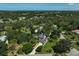 Stunning aerial view showcasing the home's placement amongst lush greenery and a tranquil pond at 13514 4Th E Plz, Bradenton, FL 34212