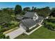 Aerial view of a home featuring a two-car garage, backyard pool, and a beautiful green lawn at 13514 4Th E Plz, Bradenton, FL 34212
