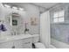Charming bathroom with marble accents, decorative mirror, and tub with shower at 13514 4Th E Plz, Bradenton, FL 34212