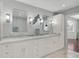 Bright bathroom featuring a double vanity with marble countertop and stylish lighting at 13514 4Th E Plz, Bradenton, FL 34212