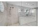 Modern bathroom showcasing a spacious walk-in shower with marble tile and a double vanity at 13514 4Th E Plz, Bradenton, FL 34212