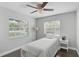 Cozy bedroom with hardwood floors, bright windows, and a ceiling fan at 13514 4Th E Plz, Bradenton, FL 34212