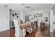 Bright dining room featuring a stylish chandelier, hardwood floors, and an adjacent modern kitchen area at 13514 4Th E Plz, Bradenton, FL 34212