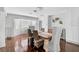 Dining area boasting hardwood floors, elegant chandelier, and a cozy bay window seating area at 13514 4Th E Plz, Bradenton, FL 34212
