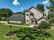 Charming two-story home with a landscaped front yard and well-maintained lawn on a sunny day at 13514 4Th E Plz, Bradenton, FL 34212