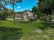 Charming home with an expansive front lawn, mature trees, and meticulous landscaping at 13514 4Th E Plz, Bradenton, FL 34212