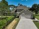 Exterior showcasing attached two-car garage, manicured landscaping, and well maintained lawn at 13514 4Th E Plz, Bradenton, FL 34212