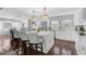 Bright kitchen with white cabinets, a marble island, pendant lighting, and stainless steel appliances at 13514 4Th E Plz, Bradenton, FL 34212